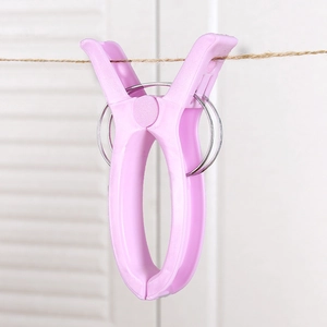 Pink heavy-duty plastic laundry clip with strong metal spring for drying quilts