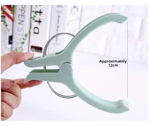 Detail of green anti-wind plastic quilt clip with 12cm reinforced metal spring for laundry