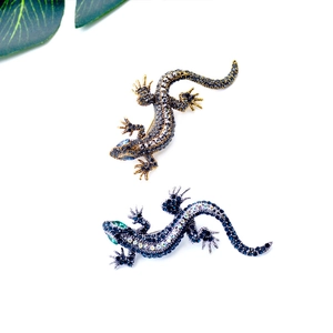 Detailed view of colorful gecko crystal brooches featuring intricate rhinestone settings