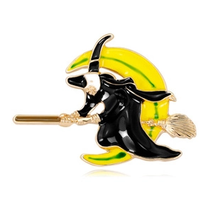 Detailed view of enamel witch flying on broom with crescent moon brooch in gold finish
