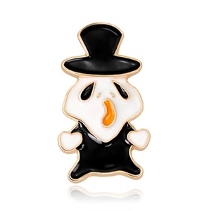 Detail of creative cartoon monster enamel pin with black top hat and polished gold edges