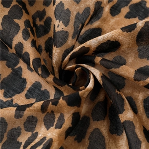 Close-up of leopard print linen-cotton fabric showing gradient texture and soft draped folds