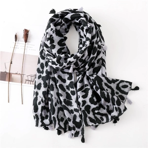 Detail of leopard print scarf with soft tassels and minimalist CEREAL magazine backdrop