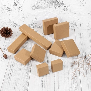 Classic dark kraft paper jewelry boxes for necklaces and rings on white wood background