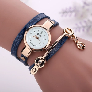 Detail of blue leather wrap bracelet watch with rose gold case and angel pendant charms