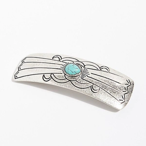 Detail of vintage silver hair clip with bohemian engraving and blue turquoise center stone