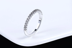 Detail of slim silver ring featuring a single row of sparkling pavé zircon stones