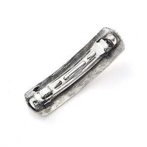 Detailed back view of vintage silver hair clip showing the durable metal spring mechanism