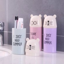 Three cute cartoon bear travel toothbrush cases in pink purple and blue on a bathroom counter