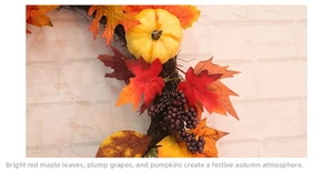 Close-up of harvest wreath with maple leaves, mini pumpkins, and purple grapes