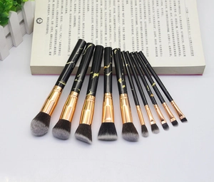 Close-up of 10-piece marble texture makeup brushes with gold ferrule and soft bristles