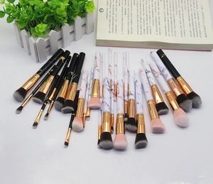 Detail of professional 25-piece marble pattern makeup brush set with rose gold ferrules