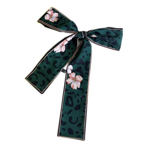 Green leopard and floral print twilly silk scarf tied in an elegant bow for women