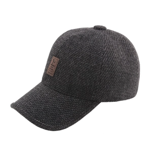 Deep grey winter baseball cap in thick knit fabric with warm ear protection and leather patch