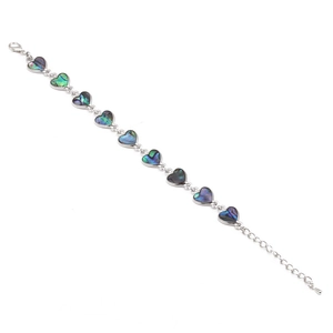 Detailed close-up of heart-shaped iridescent abalone shell inlay on silver chain bracelet