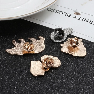 Back view of four geometric metal brooches with butterfly clutches and anti-slip textures