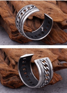 Detail of vintage Cuban link and twisted rope patterns on wide open steel cuff bracelet
