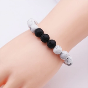 Detailed close-up of 10mm lava stone and white turquoise beaded bracelet on wrist