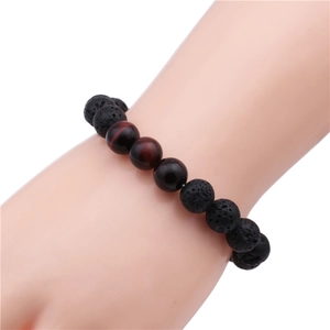 Detailed texture of 10mm black volcanic lava and red tiger eye beaded stone bracelet