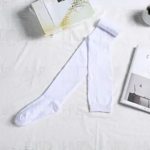 Detail shot of pure white cotton thigh high stockings on minimalist textured background