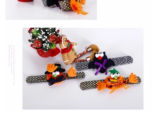 Close-up of Halloween snap bracelets with pumpkin and bat designs on white background