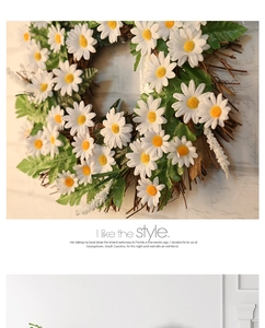 Detail of white daisy wreath with yellow centers on a natural rustic grapevine base