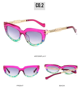 Detailed view of cat-eye sunglasses with magenta frames and gold chain temples