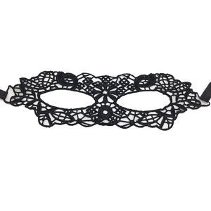 Close-up of intricate black lace masquerade mask with adjustable ribbon ties for costume