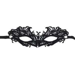 Detail showing intricate hollow lace pattern and black ties on the masquerade eye mask