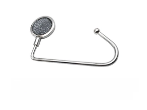 Detail of a foldable zinc alloy desk hook with a non-slip base for school bags