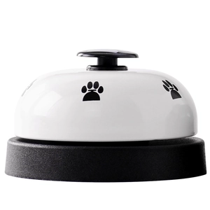 White metal pet training bell with black paw print and anti-slip base for dogs and cats