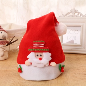 Detail of soft felt Christmas hat with Santa Claus figurine and holly berry accent