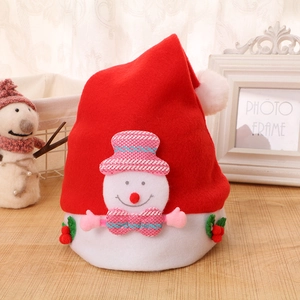 Detail of plush Christmas snowman hat with pink plaid accents and holly leaf decor