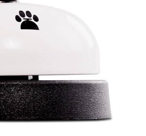 Close-up of pet training bell with paw print design and non-slip black base detail