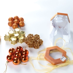 Christmas tree ornament set with orange baubles and golden gift box decorations