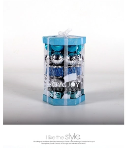 Close-up of blue and silver Christmas ball ornaments in a transparent hexagonal gift box