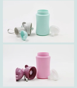 Detail showing mint green and pink kids straw cups with bear lids and clear scale marks