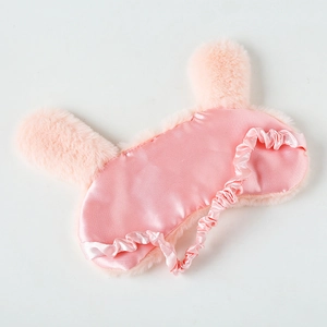 Detail of pink plush bunny eye mask showing soft faux fur and silk satin lining