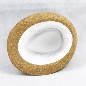 Interior detail of a straw fedora hat showing size 58 tag and white sweatband inside