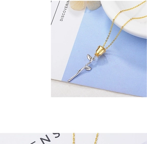 Macro detail of rose pendant with gold flower bud and silver stem on a fine chain