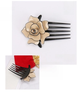 Detail view of cream flower hair comb in France acetate with measurements and black teeth