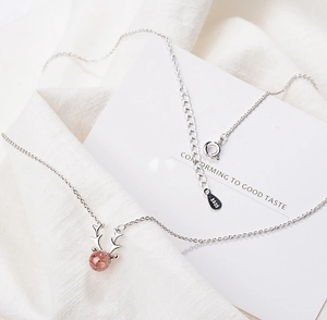 Macro shot of S925 sterling silver deer antler necklace with pink strawberry crystal