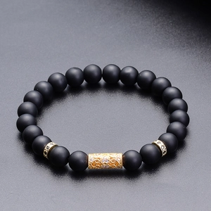 Black matte stone bead bracelet with gold hollow metal tube and micro-pave zircons