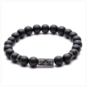 Macro shot of matte black stone beads bracelet with micro-paved white zircon copper tube