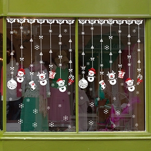 Christmas snowman and reindeer window decals set on a shop glass door display