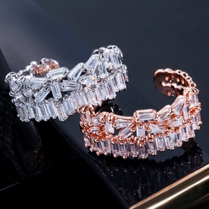 Macro detail of silver and rose gold adjustable rings with square cut cubic zirconia stones