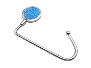 Detail of portable silver metal bag hook with a blue glittery decorative surface