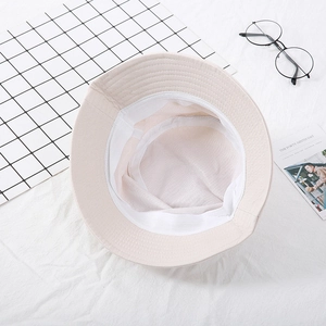 Detail view of beige bucket hat interior featuring breathable mesh lining and binding