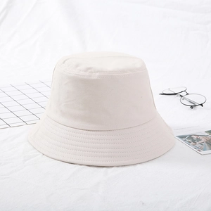 Detailed view of beige cotton bucket hat with multi-row stitching on brim and soft fabric