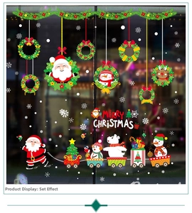 Close-up of Merry Christmas window stickers with Santa Claus and reindeer on glass